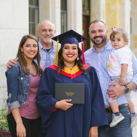 Woman in graduation cap and gown celebrating her achievement