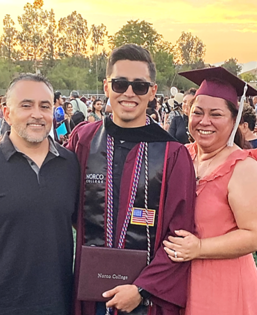 Veteran in military uniform hugging family member at graduation ceremony